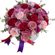 luxurious bouquet of red roses and pink carnations in a decorative box with colorful ribbons