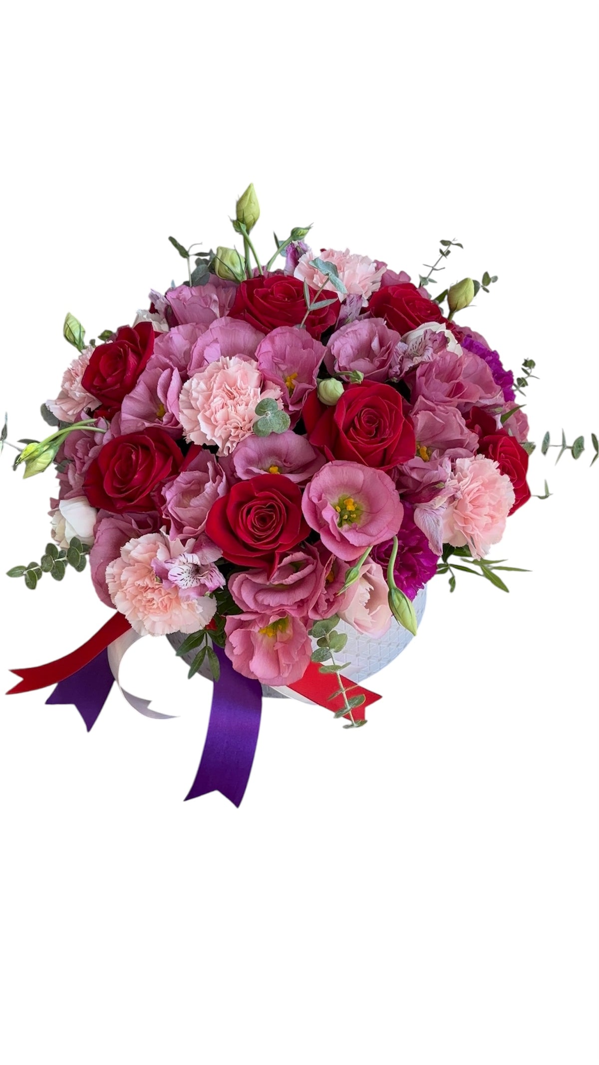 luxurious bouquet of red roses and pink carnations in a decorative box with colorful ribbons